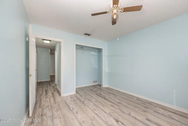 a view of room with wooden floor
