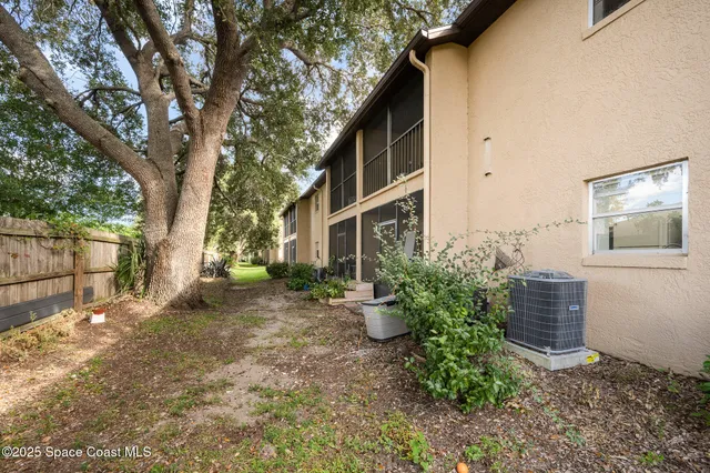 a backyard of a house with plants and outdoor seating