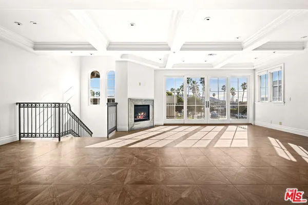 a view of an empty room with a fireplace and a window