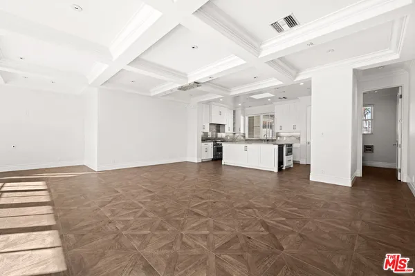 a kitchen with a stove sink and cabinets