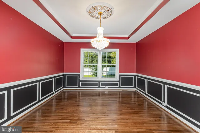a view of room with window and wooden floor