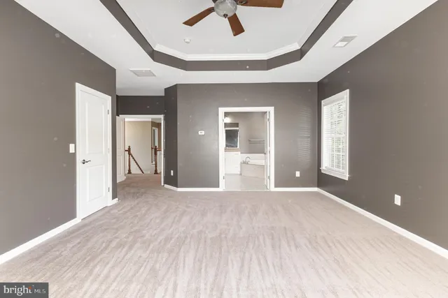 a view of a livingroom with wooden floor and a ceiling fan