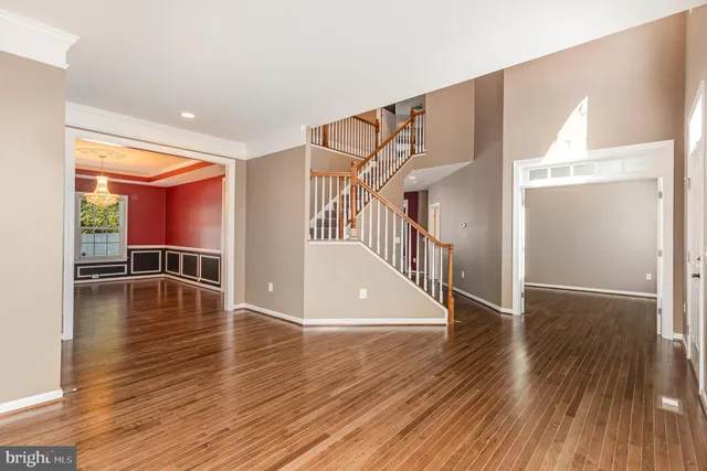 a view of a room with wooden floor and stairs