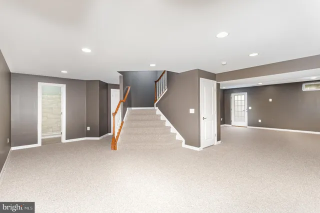 a view of an empty room with stairs