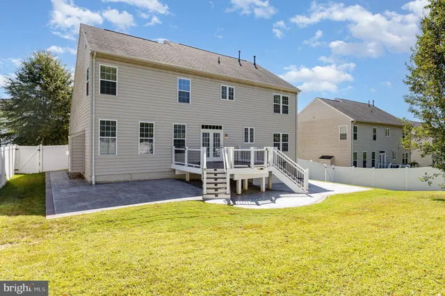 a view of a house with swimming pool and sitting area