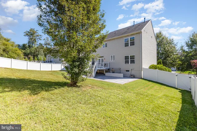 a view of a house with swimming pool and a yard