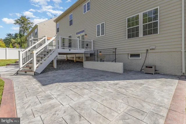 a view of house with deck and yard