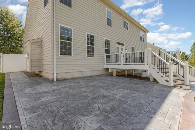 a view of a house with backyard and deck