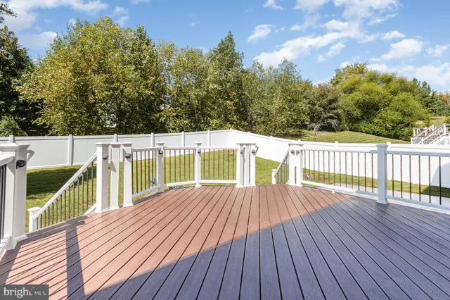 a view of a balcony with wooden floor and fence