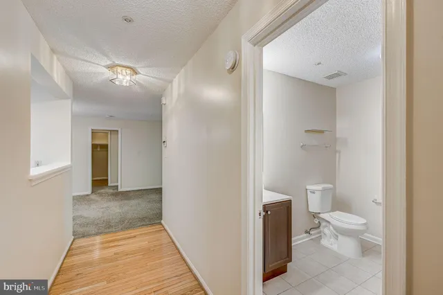 a bathroom with a toilet sink and a mirror