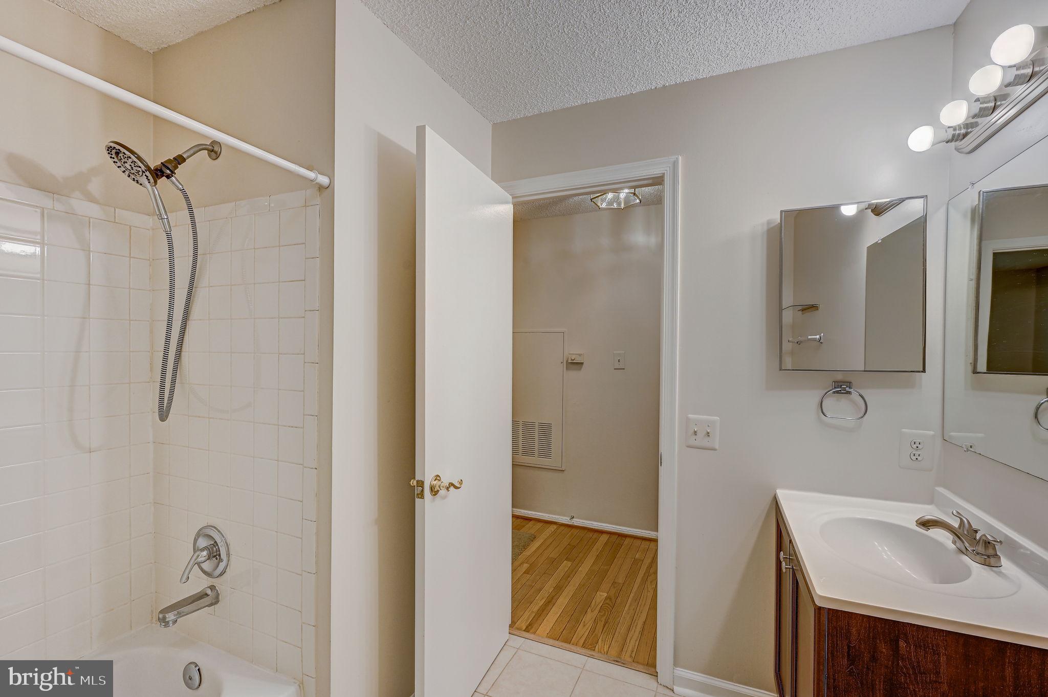 12903 Churchill Ridge Circle, Unit 6 Germantown, MD 20874 - Photo 19 of 36 a bathroom with a sink a mirror and a shower