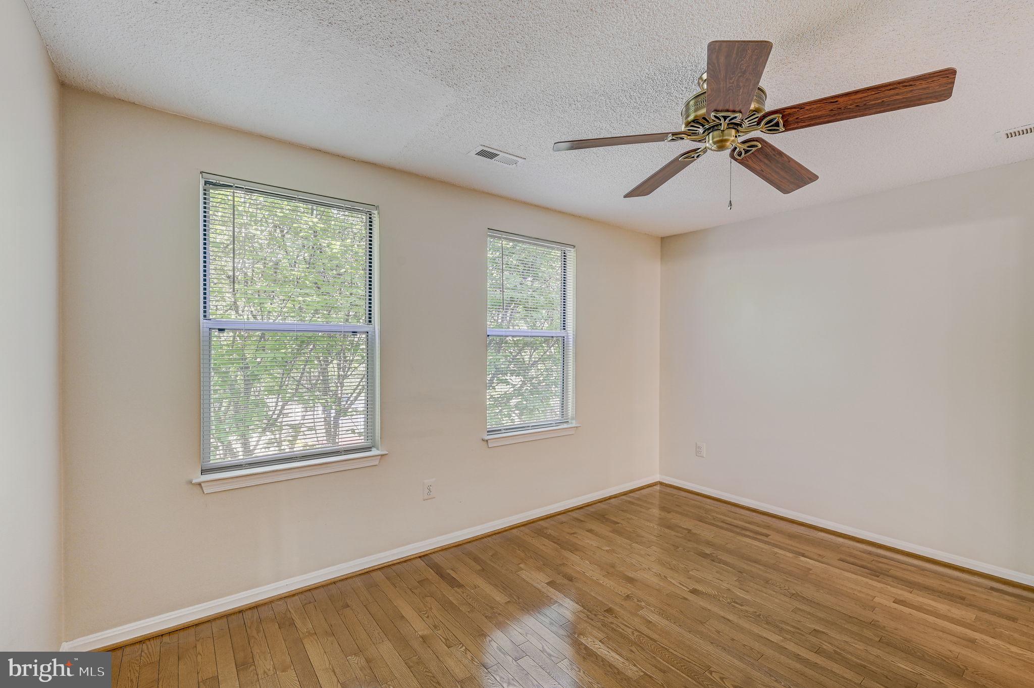 12903 Churchill Ridge Circle, Unit 6 Germantown, MD 20874 - Photo 23 of 36 a view of an empty room with a window and wooden floor