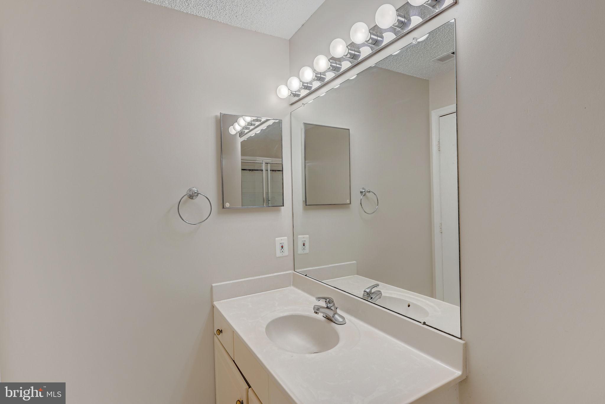12903 Churchill Ridge Circle, Unit 6 Germantown, MD 20874 - Photo 25 of 36 a bathroom with a sink and a mirror