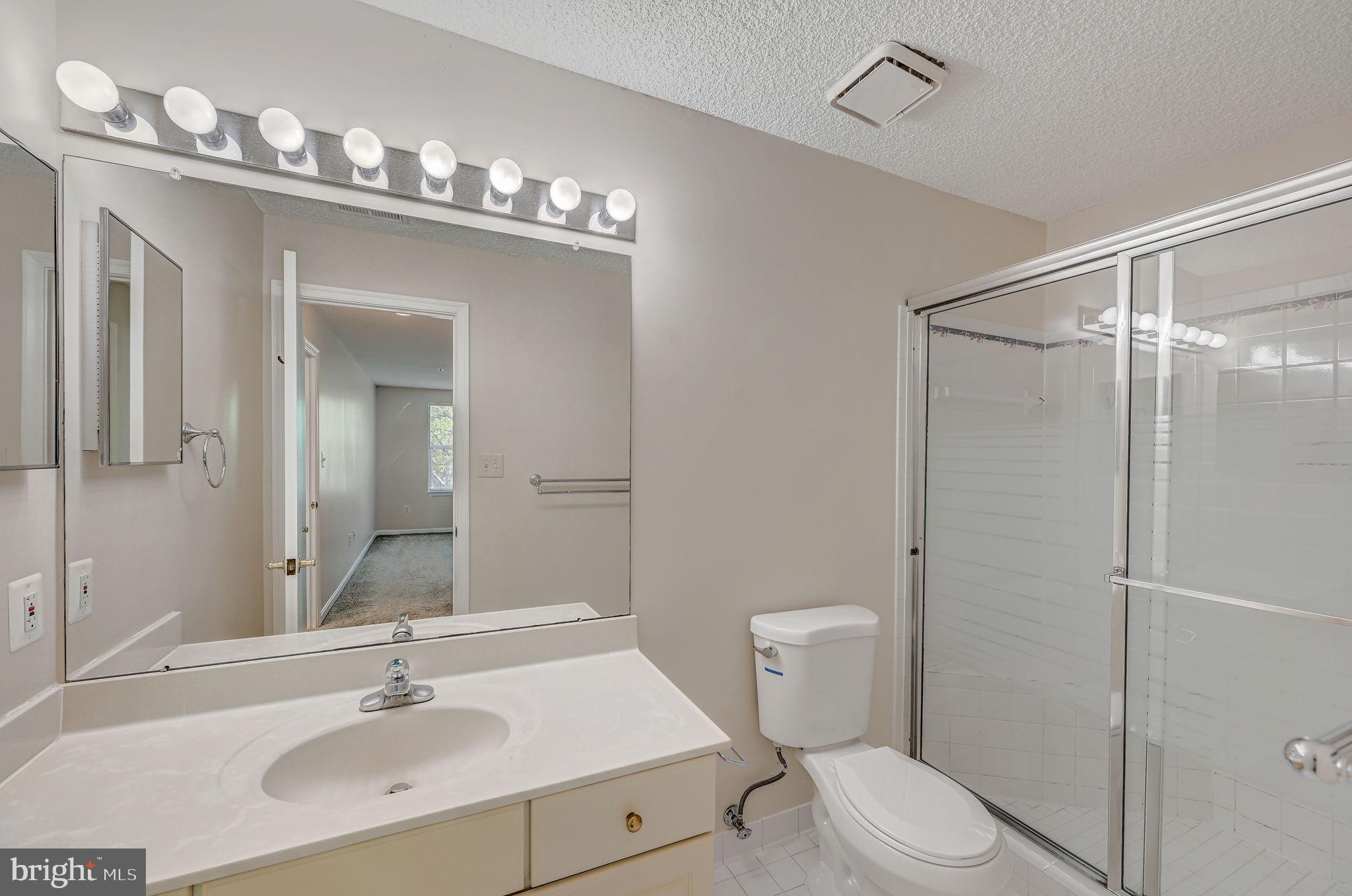 12903 Churchill Ridge Circle, Unit 6 Germantown, MD 20874 - Photo 28 of 36 a bathroom with a sink a toilet and shower