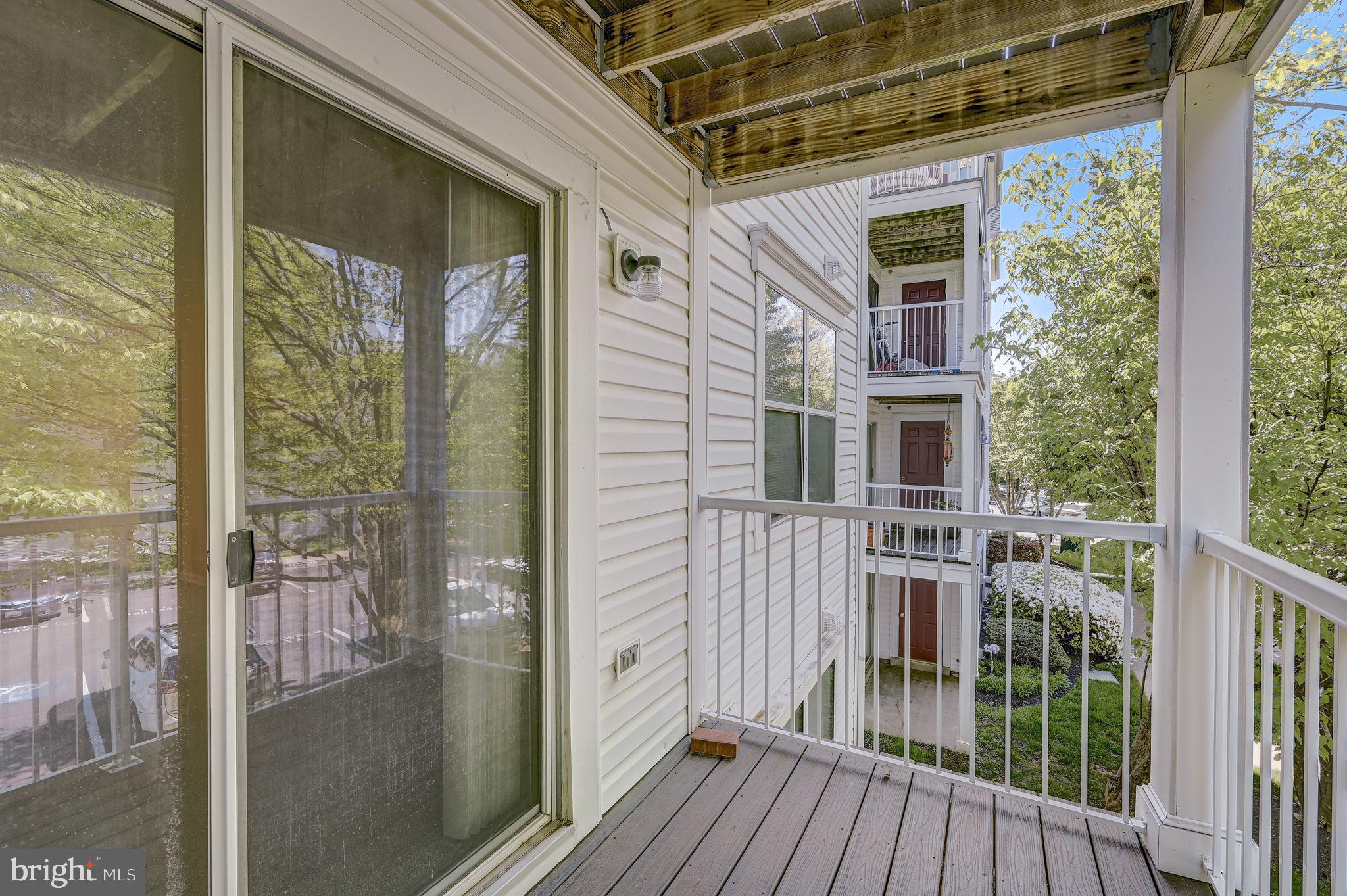 12903 Churchill Ridge Circle, Unit 6 Germantown, MD 20874 - Photo 34 of 36 a view of a balcony with wooden floor
