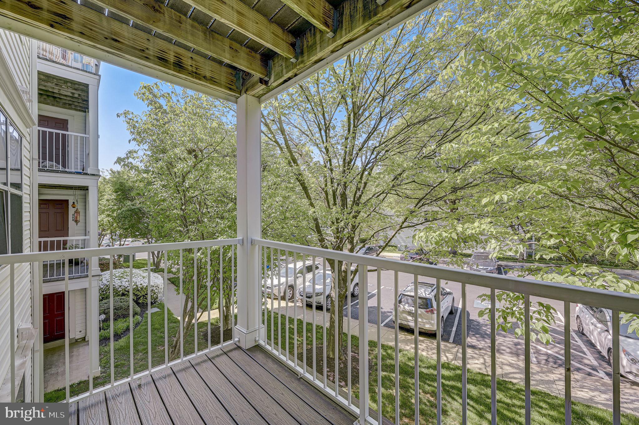 12903 Churchill Ridge Circle, Unit 6 Germantown, MD 20874 - Photo 35 of 36 a view of a balcony with wooden floor