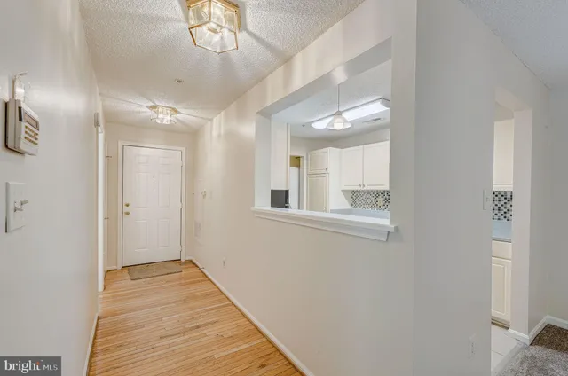 a view of a hallway with wooden floor