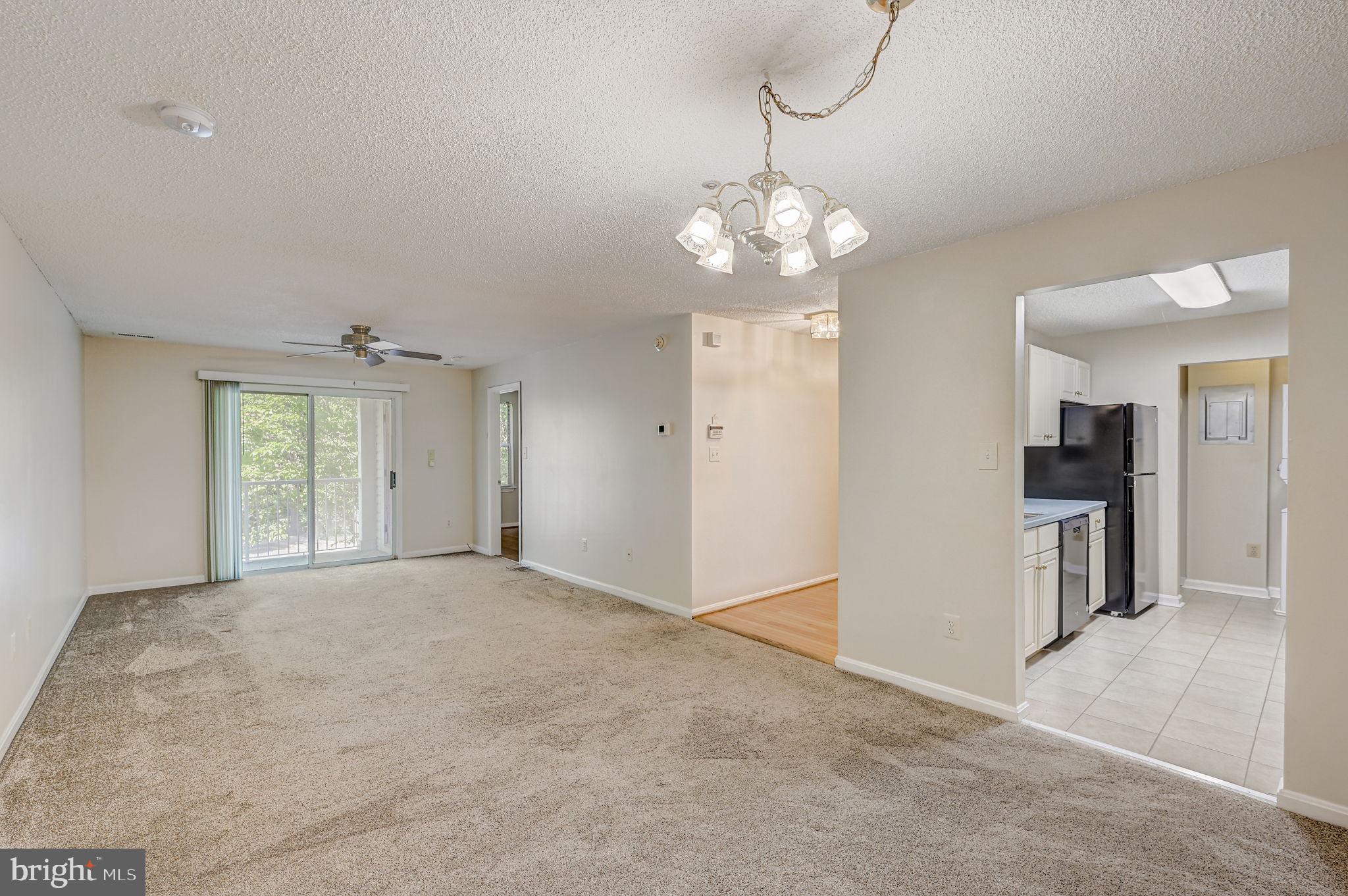 12903 Churchill Ridge Circle, Unit 6 Germantown, MD 20874 - Photo 10 of 36 a view of a livingroom with a chandelier fan and windows