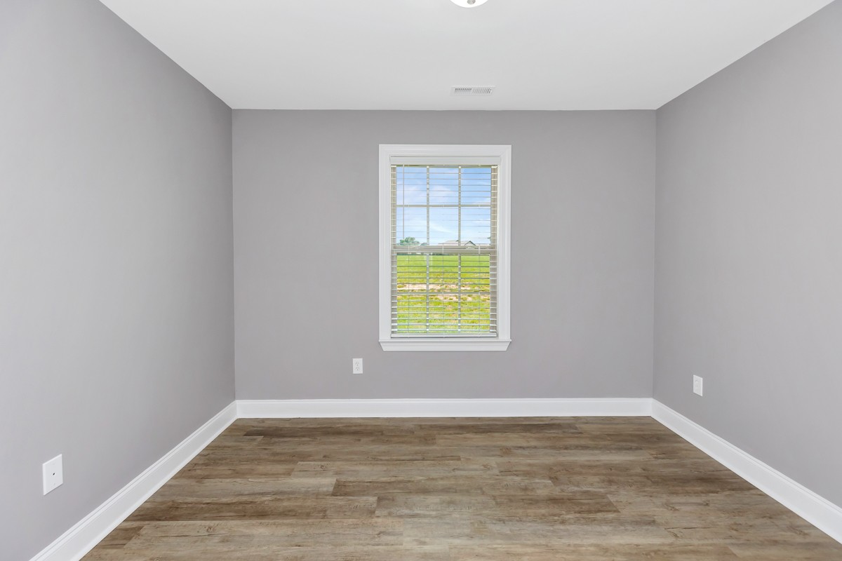 28600 Reyer Road Ardmore, AL 35739 - Photo 22 of 28 a view of an empty room with wooden floor and a window