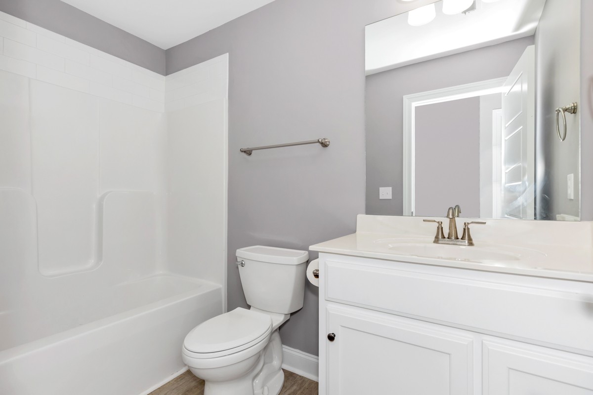 28600 Reyer Road Ardmore, AL 35739 - Photo 25 of 28 a bathroom with a sink toilet vanity mirror and shower