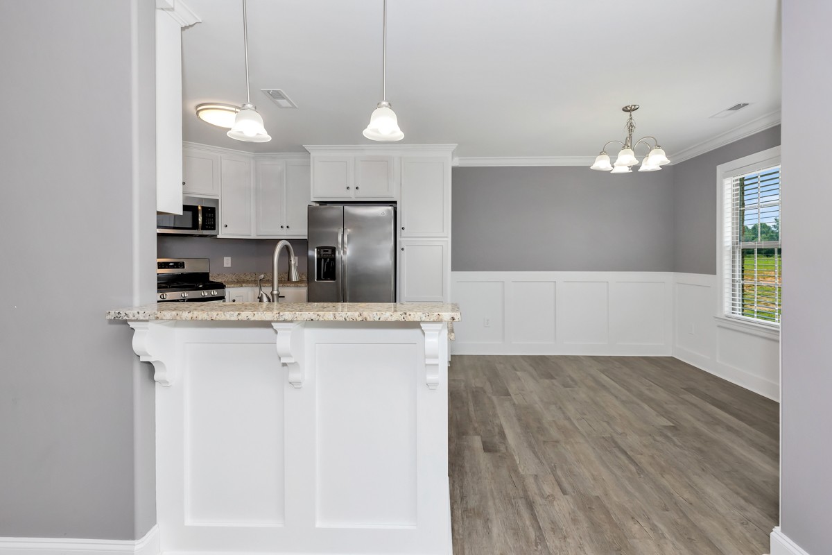 28600 Reyer Road Ardmore, AL 35739 - Photo 3 of 28 a kitchen with kitchen island granite countertop a sink cabinets a dining table and chairs