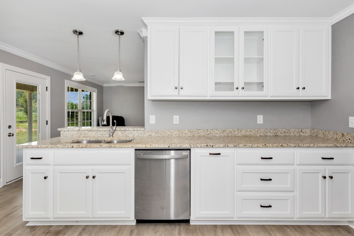 28600 Reyer Road Ardmore, AL 35739 - Photo 7 of 28 a kitchen with granite countertop white cabinets and white stainless steel appliances