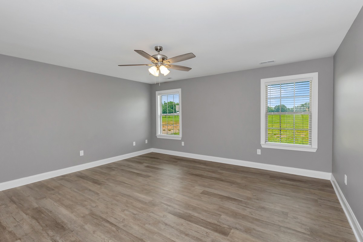 28600 Reyer Road Ardmore, AL 35739 - Photo 10 of 28 an empty room with wooden floor and windows