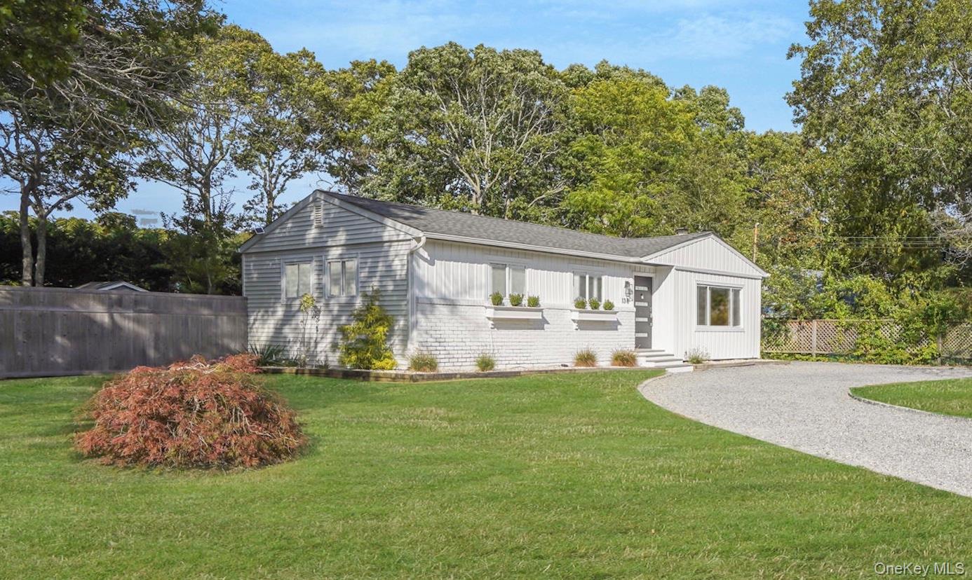 138 West Tiana Road Hampton Bays, NY 11946 - Photo 1 of 24 a front view of house with yard and trees in the background