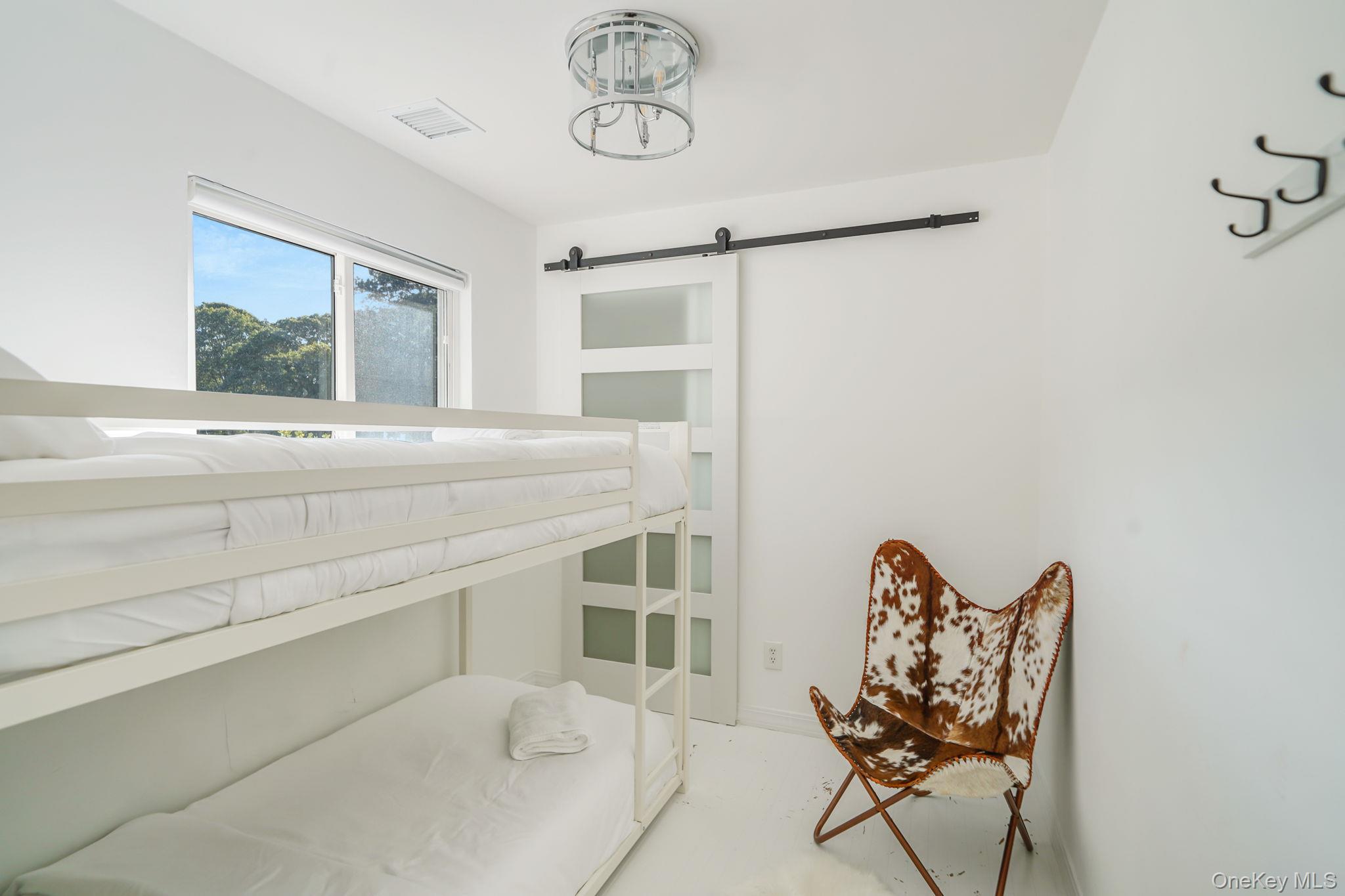 138 West Tiana Road Hampton Bays, NY 11946 - Photo 12 of 24 a living room with furniture and window