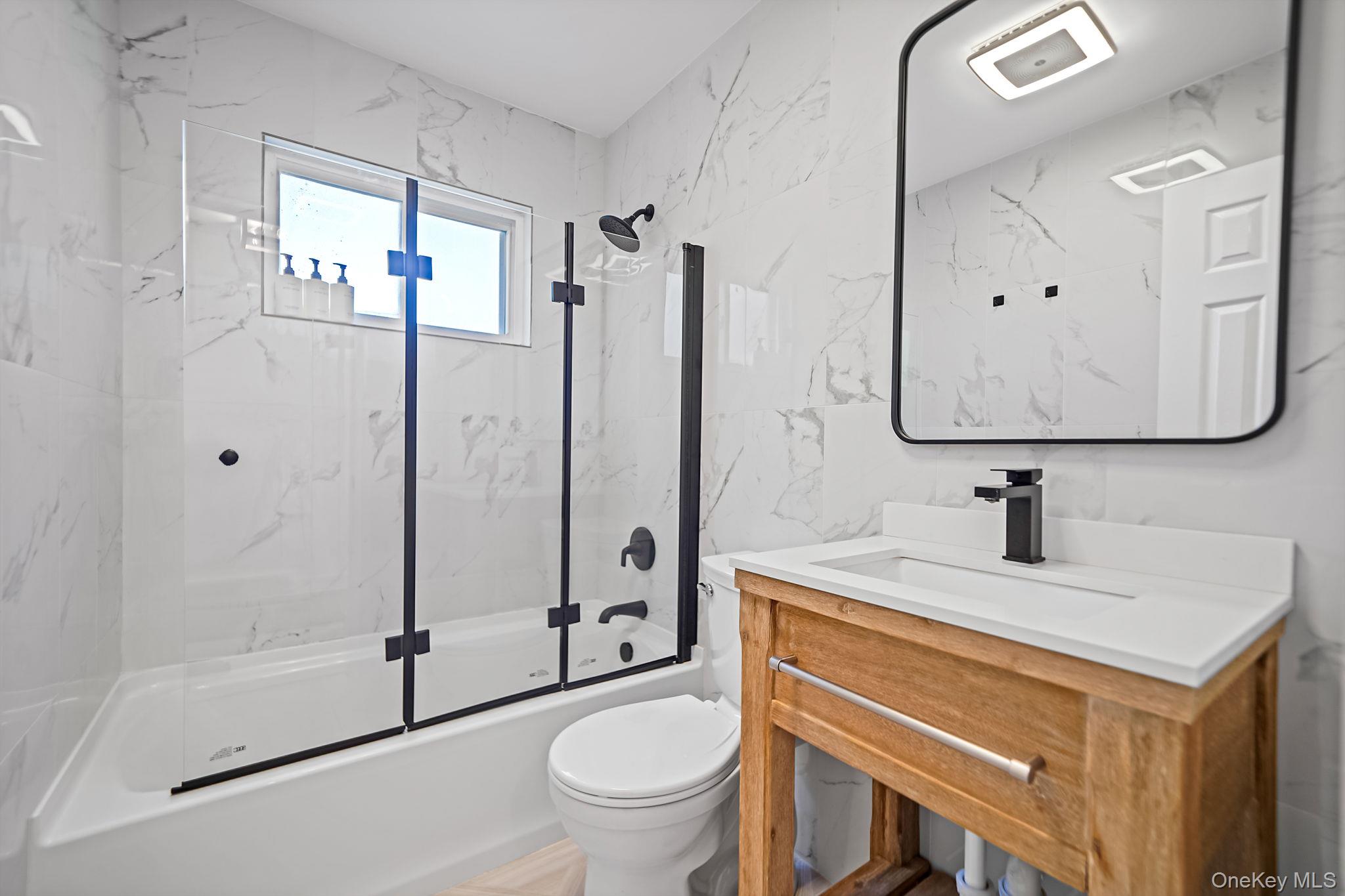 138 West Tiana Road Hampton Bays, NY 11946 - Photo 13 of 24 a bathroom with a sink toilet and shower