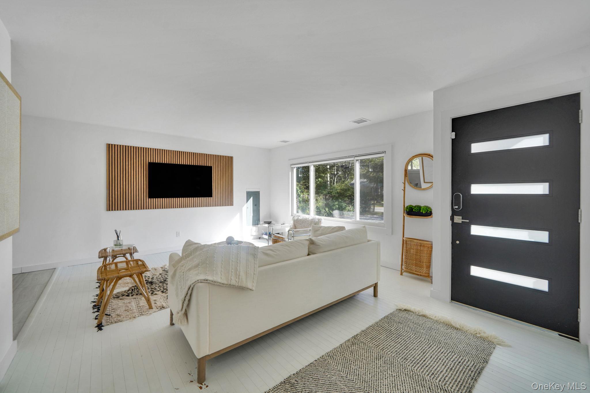 138 West Tiana Road Hampton Bays, NY 11946 - Photo 3 of 24 a living room with furniture and a flat screen tv