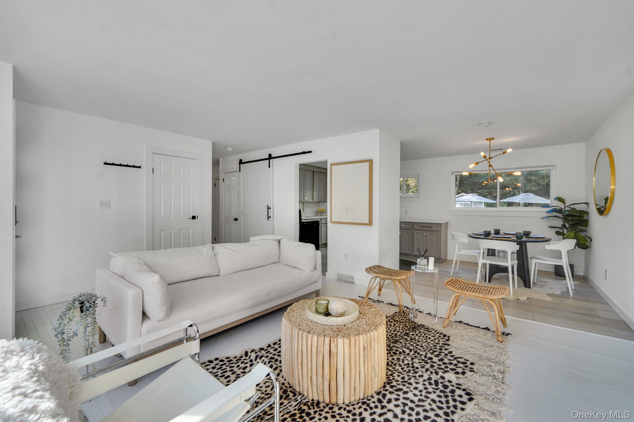 138 West Tiana Road Hampton Bays, NY 11946 - Photo 5 of 24 a living room with furniture and a table