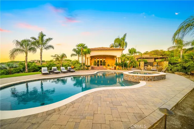 a view of a swimming pool with an outdoor seating a kitchen mountain and swimming pool