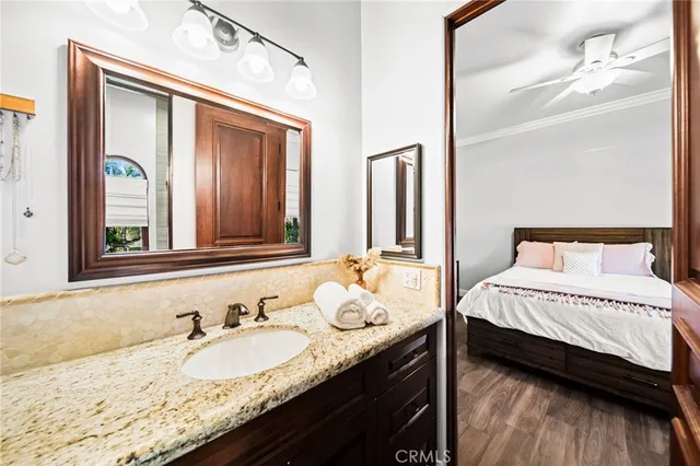 a view of a street with potted plants and large trees