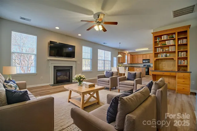 an empty room with a window and a ceiling fan