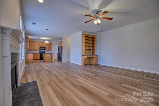 a spacious bedroom with a bed and a chandelier