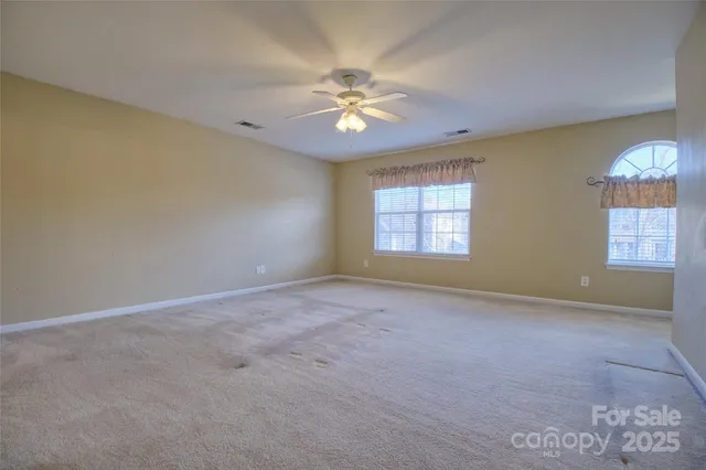 an aerial view of a house with a backyard