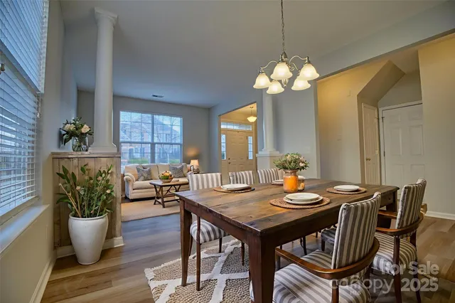 a view of a dining room with furniture and a chandelier