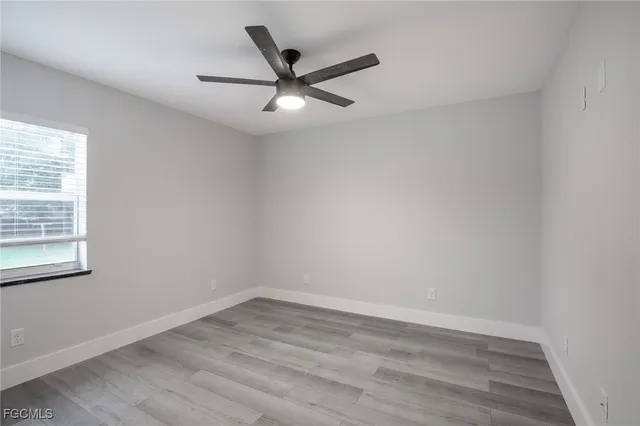 wooden floor in an empty room with a window