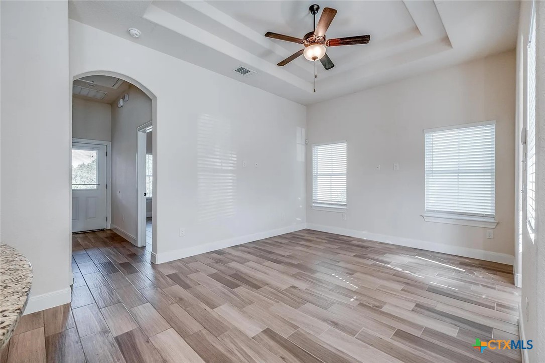 3133 Puter Creek Road, Unit B Spring Branch, TX 78070 - Photo 4 of 19 wooden floor in an empty room with a window