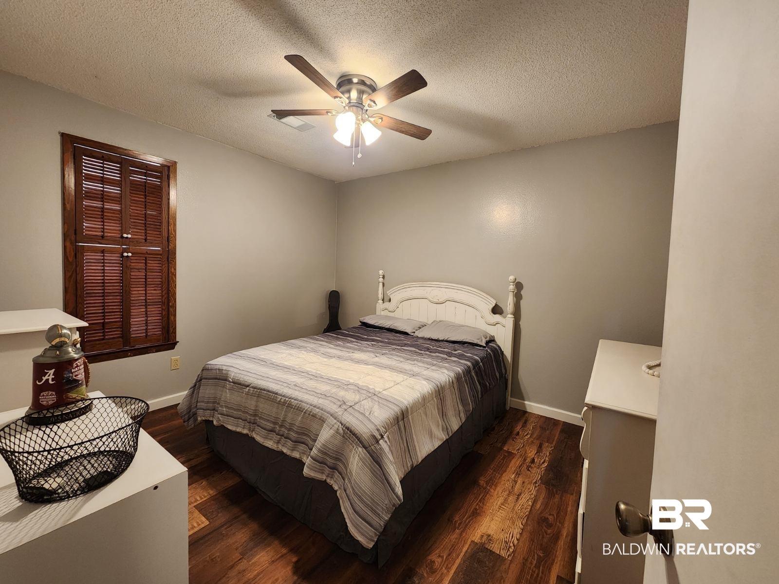 640 Horseshoe Road Brewton, AL 36426 - Photo 16 of 22 Bedroom featuring dark hardwood / wood-style flooring, a textured ceiling, and ceiling fan
