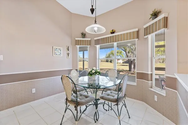 a view of a dining room with furniture wooden floor and chandelier