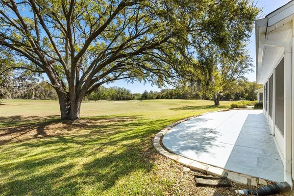 a front view of a house with a garden and trees