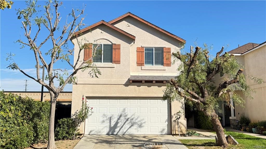 24854 Noelle Way Newhall, CA 91321 - Photo 1 of 1 a front view of a house with a garden