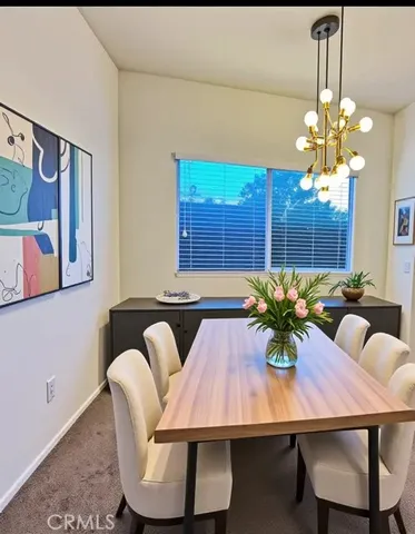 a view of a dining room with furniture and chandelier