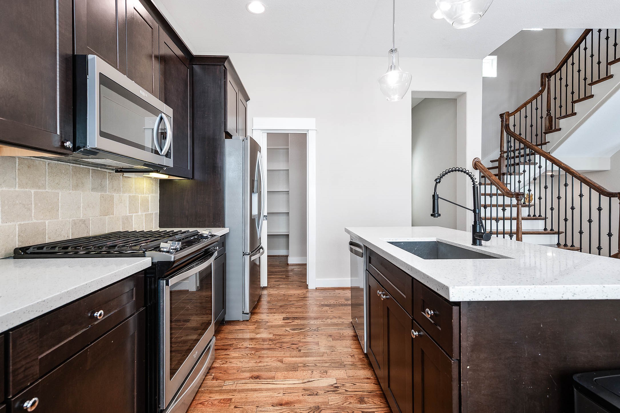 a kitchen with stainless steel appliances granite countertop a sink stove and refrigerator
