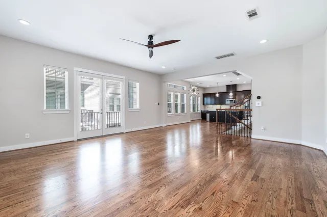 a kitchen with stainless steel appliances a sink cabinets and wooden floor