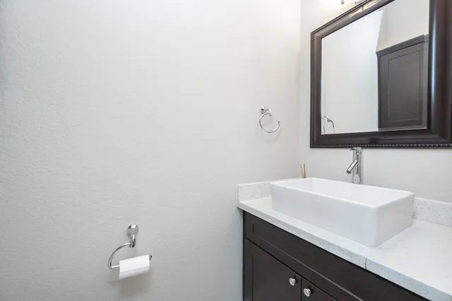 a kitchen with stainless steel appliances a kitchen island wooden floors and a sink