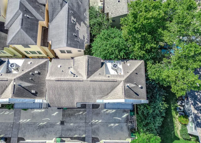 an aerial view of multiple houses with yard