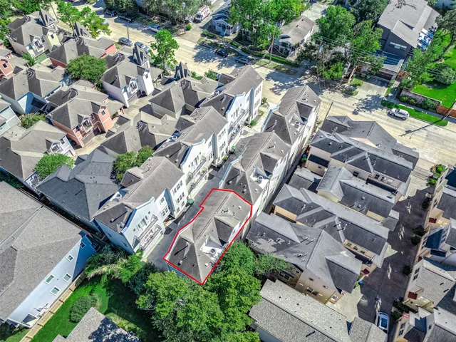 an aerial view of a residential houses with outdoor space